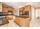 Bright kitchen features wooden cabinetry, tile flooring, and a black granite countertop island at 317 Saint Pauls Ct, Stockbridge, GA 30281