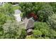 Aerial view of a secluded home with mature trees and well-maintained landscaping and a long driveway at 4300 May Apple Dr, Alpharetta, GA 30005