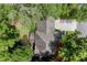 Aerial view shows roof and greenery with driveway and neighborhood street at 4300 May Apple Dr, Alpharetta, GA 30005