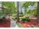 Beautifully landscaped backyard with mulch, trees, and walkway with serene and private outdoor space at 4300 May Apple Dr, Alpharetta, GA 30005