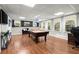 Finished basement featuring a pool table, neutral walls, and wood look flooring at 4300 May Apple Dr, Alpharetta, GA 30005
