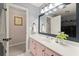 Bright bathroom featuring pink vanity, fresh white countertops, and a large framed mirror at 4300 May Apple Dr, Alpharetta, GA 30005