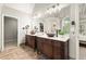 Spacious bathroom featuring double vanities, tile floors, and modern fixtures at 4300 May Apple Dr, Alpharetta, GA 30005