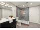 Modern bathroom featuring a glass-enclosed shower with tiled walls and a sleek vanity at 4300 May Apple Dr, Alpharetta, GA 30005