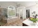 Bright bathroom featuring a soaking tub, glass shower, and wooden accents at 4300 May Apple Dr, Alpharetta, GA 30005