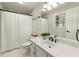 Bathroom with a shower and tub featuring sleek white cabinets and modern fixtures at 4300 May Apple Dr, Alpharetta, GA 30005