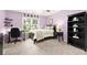 Bedroom featuring a black desk, shelving, and large window with a leafy view at 4300 May Apple Dr, Alpharetta, GA 30005