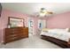 Bedroom with pink walls, large windows, and an ensuite bathroom at 4300 May Apple Dr, Alpharetta, GA 30005