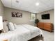 Cozy bedroom with a queen bed, wooden dresser, and neutral decor for a relaxing ambiance at 4300 May Apple Dr, Alpharetta, GA 30005