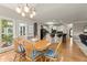 Bright dining area with wood table, chair cushions, and an elegant chandelier at 4300 May Apple Dr, Alpharetta, GA 30005