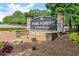 Stone community sign for Park Forest at Park Bridge, surrounded by manicured landscaping and trees at 4300 May Apple Dr, Alpharetta, GA 30005