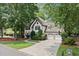Two story home with three car garage, basketball hoop, and well manicured lawn at 4300 May Apple Dr, Alpharetta, GA 30005