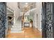 Inviting foyer with gleaming hardwood floors, staircase with iron spindles, and access to other rooms at 4300 May Apple Dr, Alpharetta, GA 30005