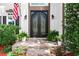 Elegant wrought-iron double front doors flanked by lush greenery, welcoming guests with sophistication at 4300 May Apple Dr, Alpharetta, GA 30005