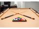 Close up on a pool table with balls and cues in a well-lit recreation room at 4300 May Apple Dr, Alpharetta, GA 30005