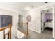 Open hallway with decorative details leading to a bedroom with a purple accent wall at 4300 May Apple Dr, Alpharetta, GA 30005