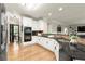 Open kitchen featuring white cabinets, granite countertops, stainless steel appliances, and hardwood floors at 4300 May Apple Dr, Alpharetta, GA 30005