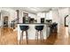 Kitchen with white cabinets, granite countertop, and barstool seating at 4300 May Apple Dr, Alpharetta, GA 30005