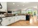 Open kitchen featuring white cabinets, stainless steel appliances, granite countertops, and eat-in breakfast area at 4300 May Apple Dr, Alpharetta, GA 30005