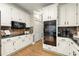 Spacious kitchen with white cabinets, granite countertops, stainless steel appliances, and modern finishes at 4300 May Apple Dr, Alpharetta, GA 30005
