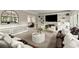 Spacious living room boasts built-in shelving, a fireplace, and comfortable seating arrangements at 4300 May Apple Dr, Alpharetta, GA 30005