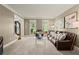 Bright living room with large windows, plush carpeting, and comfortable leather seating at 4300 May Apple Dr, Alpharetta, GA 30005