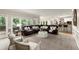 Expansive living room with abundant natural light, modern decor, and comfortable furniture at 4300 May Apple Dr, Alpharetta, GA 30005