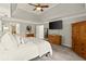 Bright main bedroom featuring a trey ceiling, tv, and neutral decor at 4300 May Apple Dr, Alpharetta, GA 30005