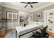 Well-lit home office with a stylish desk, built-in shelving, French doors, and hardwood floors at 4300 May Apple Dr, Alpharetta, GA 30005