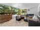 Covered patio with stone flooring, comfortable seating, and a foosball table at 4300 May Apple Dr, Alpharetta, GA 30005