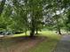 Community playground and walking path surrounded by mature trees and green spaces at 4300 May Apple Dr, Alpharetta, GA 30005