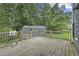 An elevated, gated, wooden back deck with view of a storage shed at 5242 Mccarter Sta, Stone Mountain, GA 30088