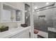 Modern bathroom featuring tiled walk-in shower, neutral paint, decorative mirror, and built-in vanity at 5242 Mccarter Sta, Stone Mountain, GA 30088