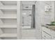 Bright bathroom with a shower-tub combo and built-in shelving at 5242 Mccarter Sta, Stone Mountain, GA 30088