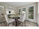 Bright breakfast nook with natural lighting, backyard views, and a modern glass-top round dining table at 5242 Mccarter Sta, Stone Mountain, GA 30088