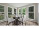 Bright breakfast nook with natural lighting, backyard views, and a modern glass-top round dining table at 5242 Mccarter Sta, Stone Mountain, GA 30088
