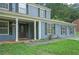 Traditional two-story home with blue siding, black shutters, and a covered front porch at 5242 Mccarter Sta, Stone Mountain, GA 30088