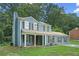 Charming two-story home with blue siding, black shutters, an attached garage, and a covered front porch at 5242 Mccarter Sta, Stone Mountain, GA 30088