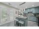 Stylish kitchen featuring a center island, gray cabinetry, stainless appliances, and access to a fenced backyard at 5242 Mccarter Sta, Stone Mountain, GA 30088