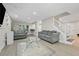 Bright living room with hardwood floors, neutral paint, large windows, recessed lighting, and staircase to second floor at 5242 Mccarter Sta, Stone Mountain, GA 30088