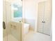 Modern bathroom boasts soaking tub, tiled shower with glass door, and built-in shelves at 6525 Rhett Run, Cumming, GA 30028
