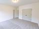 Bright bedroom featuring neutral walls, carpet and closet with double doors at 6525 Rhett Run, Cumming, GA 30028