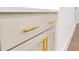 Close up of kitchen cabinetry with long, gold, bar-style handles at 6525 Rhett Run, Cumming, GA 30028
