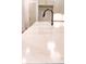 White countertop featuring gold veining accents with black faucet at 6525 Rhett Run, Cumming, GA 30028