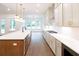 Modern kitchen features a spacious island with stainless steel appliances, hardwood floors, and plenty of counter space at 6525 Rhett Run, Cumming, GA 30028