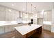 Modern kitchen features a spacious island, stainless appliances, hardwood floors, and plenty of cabinet space at 6525 Rhett Run, Cumming, GA 30028