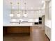 Modern kitchen features a spacious island, stainless appliances, hardwood floors, and plenty of cabinet space at 6525 Rhett Run, Cumming, GA 30028