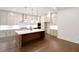 Modern kitchen features a spacious island, stainless appliances, hardwood floors, and plenty of cabinet space at 6525 Rhett Run, Cumming, GA 30028