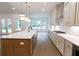 Modern kitchen features a spacious island with stainless steel appliances, hardwood floors, and plenty of counter space at 6525 Rhett Run, Cumming, GA 30028