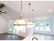 Open concept living space featuring globe pendant lights and many windows at 6525 Rhett Run, Cumming, GA 30028